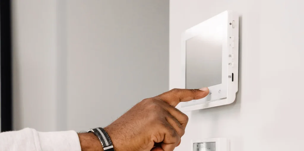 Electrician installing ceiling light in a modern New Zealand home