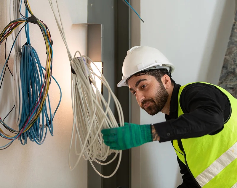 In Charge Electrical electrician wearing safety gear on site